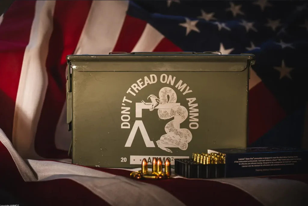 A professional photo of a stacked pallet of 1,000-round ammunition cases in a climate-controlled warehouse.]